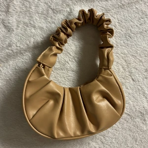 Liten handväska - En supersöt liten handväska.  Rymmer telefon, nycklar och lipsyl men absolut inte mer än så 😅Minns tyvärr inte vart den kommer från.