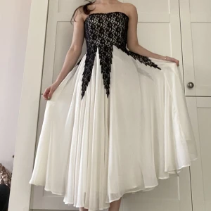 Formal dress - Only worn once, good condition. Really flowy, muted white dress (ankle length). Black lace on the top of the dress. A (well hidden) zipper going down the side of the top of the dress for a good fit