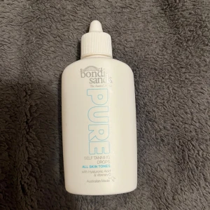 Bondi Sands Pure Self Tanning Drops - Bondi Sands Pure Self Tanning Drops för alla hudtoner. Kommer i en vit plastflaska med pipettlock, innehåller hyaluronsyra och vitamin C. Perfekt för att blanda med din ansiktskräm för en naturlig solkysst look. Endast testad