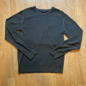 Grå stickad tröja från J.Lindeberg - Säljer en grå stickad tröja från J.Lindeberg i storlek S. Tröjan har ett diskret vågigt mönster över hela ytan och är långärmad med rund halsringning. Perfekt för hösten och är varm och har en bra passform. Är i mycket bra skick och väldigt skön! Kan gå ner vid pris vid snabbt köp🙌 