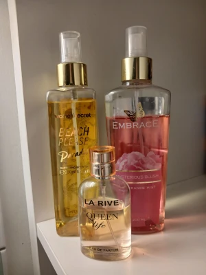 Två bodymist och en handväskevänlig parfym💕 - Hej! Säljer dessa godingar tillsammans men kan köpa en av de också eller två. Bodymists "Beach please" Paradise av Womens secret (250 ml) glitter på kroppen samt ljuvlig doft, Embrace "Mysterious blush (200 ml)som luktar friskt och sött, rosor. Den lilla parfymflaskan La Rive "Queen of life" ca (30 ml) perfekt att ha med sig överallt och dryg. Alla flaskor har använts med några sprut här och där, men har mycket kvar att ge, dryga allihopa 💗🌸 