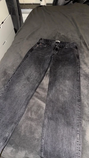 Grå jeansbyxor från Gina tricot - Säljer ett par grå jeansbyxor från Perfect Jeans med klassisk femficksdesign och raka ben. Jeansen har en snygg tvättad look och är tillverkade i denimtyg. Passar perfekt till en avslappnad stil och har normal passform.