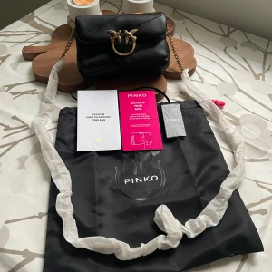 Pinko Love Puff mini micro shoulder bag - Brand new Pinko Love Puff micro shoulder bag, color black. Dimensions are shown in the pictures. The bag is pretty small, but super stylish. It fits the basics like your keys, earphones, and a small cardholder or wallet.  • Product number: P6951H174-Q11 • Supplier model ID: 100041A0F2-Z99Q  	•	Detachable shoulder strap 	•	Outer material: leather 	•	Handle length: 50 cm. More pics: https://www.vinted.fi/items/7145710247-pinko-love-puff-mini-micro-shoulder-bag