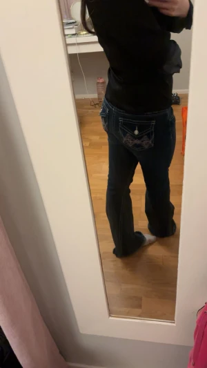 Iconic twisted jeans Gina tricot  - Mörkblå bootcut jeans från Gina Tricot i storlek 170. Snygga broderade detaljer på bakfickorna med silverfärgade knappar. Klassisk femficksmodell med kontrastsömmar och låg midja. Perfekt för dig som gillar retrovibbar och coola detaljer. Slutsåld på hemsidan men det finns tecken på användning och att byxorna har varit för långa (sista bilderna)