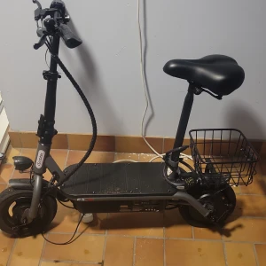 E-scooter F2 med sadel och korg - Elektrisk sparkcykel med sadel, korg och digital display. Utrustad med nyckelstart, handbroms och robusta däck. Laddare medföljer. Ny skick och kartongen finns och allt som tillhör scootern finns. Hastigheten är från 30km/h till 35 och räckvidden är från 25 km till 30 km  och den väger 17.5 kg och längden är 115cm tyngden som den håller är 120 kg 