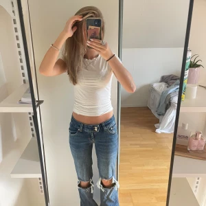Lågmidjade mörkblåa jeans  - Säljer lågmidjade bootcut jeans med hål från Lager157. Storlek xs short. Bara andvänt dem fåtal gånger. Jätte snygga💕💕