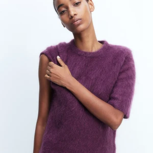 Hm premium mohair tröja - Supermjuk plommon lila stickad tröja med kort ärm och rund hals. Tröjan har en fluffig yta och är perfekt för dig som gillar en chill men ändå trendig look. Passar snyggt till både jeans och kjol. Materialet känns lyxigt och ger en cool vibe.