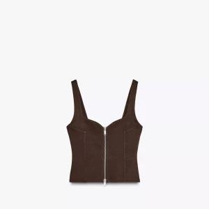 Brun korsett-topp med dragkedja - Säljer en brun korsett-topp med breda axelband och markerad byst. Toppen har en snygg silverfärgad dragkedja framtill och är croppad i modellen. Perfekt att styla med jeans eller kjol för en trendig look.