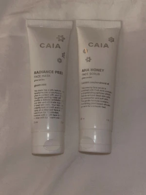 CAIA Radiance Peel & AHA Honey Scrub - Två vita tuber från CAIA glow series: Radiance Peel Face Mask med glycerin och AHA, samt AHA Honey Face Scrub med fruktsyra och mandelolja. Båda är 30 ml och har snöflinge-detaljer på förpackningen. Perfekt för exfoliering och mjuk hud. Limited edition, pris kan diskuteras💕Andvända endast en gång så nästan helt fulla. 