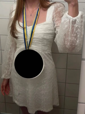 Vit studentklänning Bubbleroom - Studentklänning från Bubbleroom, använd en gång på studenten, inget tecken på användning. Blev inte för varm eller sval på studentdagen, bekväm. Storlek 36 men passar även mig som är längre.