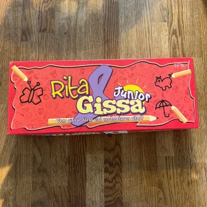 Rita & Gissa Junior - Ett roligt och kreativt spel där du ritar och gissar tillsammans med vänner! Perfekt för yngre spelare, med enkla kategorier som djur, saker och personer. Utmana dina kompisar och se vem som gissar rätt först. Passar för 3-6 spelare och garanterar många skratt!