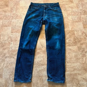 Mc Gordon  blå jeans straight fit - Klassiska blå jeans med rak passform och femficksdesign. Jeansen har en snygg tvätt med slitningar och naturliga skuggningar. Tillverkade i robust denim med knappgylf och normala bakfickor. Perfekta för en avslappnad och tidlös look.