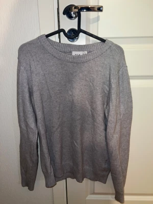 Grå stickad tröja - En grå stickad tröja, aldrig använd sedan köpt. Bra skick, inget att klagga på.