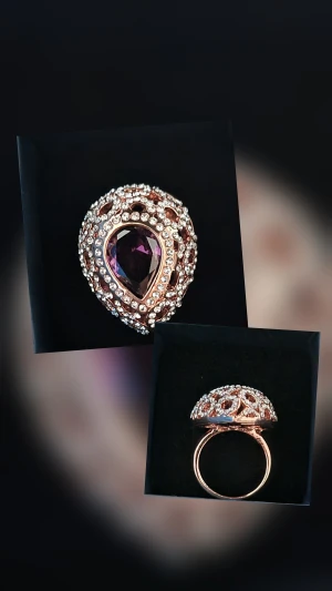 Glittrig ring med lila sten - Säljer en riktigt snygg ring i roséguld med en stor droppformad lila sten i mitten. Ringen är dekorerad med massor av små glittrande stenar runt om som ger extra bling. Perfekt för dig som gillar statement-smycken och vill sticka ut.