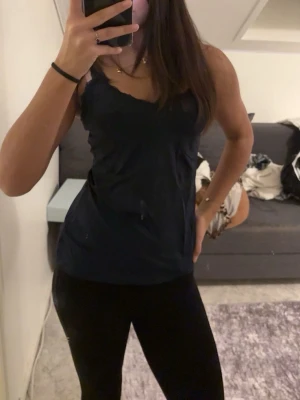 marinblått linne med spetskant - Säljer min marinblåa spetstopp ifrån Lindex i storlek L, tajt upp till men pösig ner till då jag vanligtvis har storlek XS eller S men passar alla storlekar, säljer pga att den aldrig används.