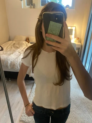 Vit T-shirt Zara - En enkel vit t-shirt från Zara gjort på 100% bomull med en fin ribbad design. Toppen faller fint, har lite längre ärmar och passar perfekt till både jeans och kjol. En basic topp som passar till allt och är super snygg. Köpte för 180kr och har använt ett fåtal gånger