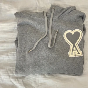 Ami Paris hoodie - Säljer min gråa ami Paris hoodie helt ny bara använda en gång, kan skicka bättre bilder om man ber om det😁.pris kan diskuteras vid snabb affär 👍