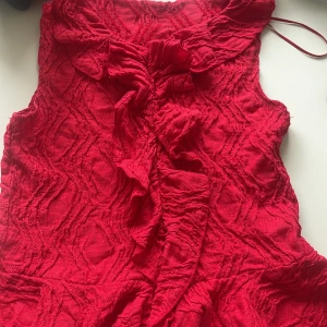 Jätte fin röd blus från gina.   - Blusen är i bra skick men vet tyvärr inte vilken storlek den är. Tror den är storlek 146/152. Den är andvänd fåtal gånger och har ingen skada