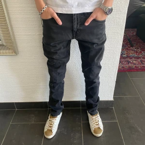 Tiger Of Sweden Jeans - Svarta jeansbyxor från tiger of Sweden i modellen 'Pistolero'. Klassisk femficksdesign, raka ben och normal passform. Jeansen har snygga sömmdetaljer och är tillverkade i ett slitstarkt bomullstyg. Perfekta för dig som gillar en stilren look.