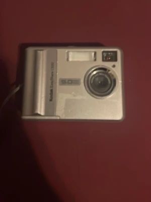 Kodak EasyShare C530 - Kodak EasyShare C530 digitalkamera med 5.0 megapixlar. Kameran är i använt skick med synligt slitage, men displayen fungerar och inga uppenbara skador på linsen. Perfekt för dig som vill ha en enkel och pålitlig kompaktkamera.