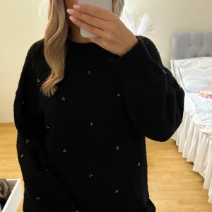 Svart stickad tröja  - Svart stickad tröja från H&M i storlek M. Tröjan har rund halsringning, lång ärm och är dekorerad med små silver/svart-färgade pärlor över hela plagget. Den har tappat en pärla längst ner och det är verkligen inget man tänker på 💞💞