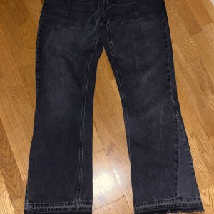Gråa wide jeans från Zara - Säljer ett par gråa jeans från Zara i modell med breda ben. Jeansen har klassisk femficksdesign, knapp och dragkedja framtill samt tydliga sömmar. Materialet är jeans och färgen är en snygg tvättad grå nyans.