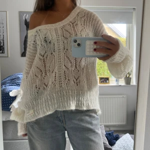 Vit stickad offshoulder-tröja - Säljer en superfin vit stickad tröja med offshoulder-look och genombrutet mönster. Tröjan är oversized med långa ärmar och bred mudd nertill.💓💓