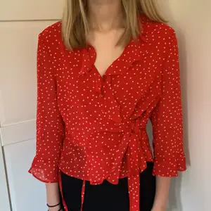 Röd blus från Bardot med vita prickar, man knyter den på båda sidor. Aldrig använd, det är en storlek 42 men den går att knyta hårdare💗