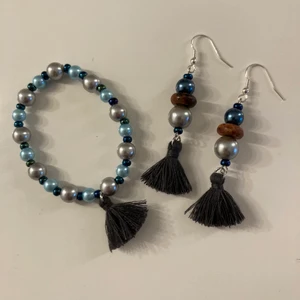 Earings and a matching bracelets. - Hand made bohemian earrings and bracelets set, this unique and one of of a kind set is made with metallic blue pearls and looks beautiful in the sunlight. 