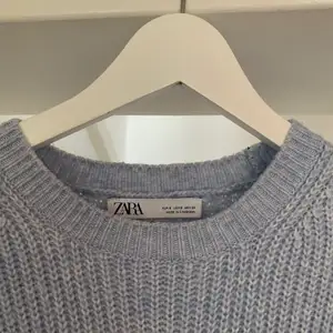 Superfin ljusblå stickad tröja med fin detalj på ärmarna från Zara. En gammal favorit, så välanvänd och lite nopprig. Den har även en lös maska på baksidan (sista bilden). Fri frakt!!🤩