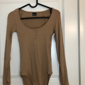 Brun body - En brun body från Gina Tricot, oanvänd