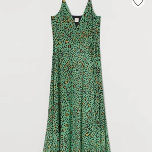 Klänning - En charmig mönstrad grön klänning från H&M, enbart använd ett fåtal gånger. Eftersom det är en omlottklänning så är den justerbar runtom samt att man kan justera banden på axlarna. Ordinariepris 159kr