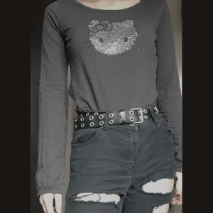 Hello Kitty-tröja - Supersöt långärmad Hello Kitty-tröja från H&M med strass. Som det syns är ärmarna liite för långa på mig som är 162 cm. Skickar gärna fler bilder på den!