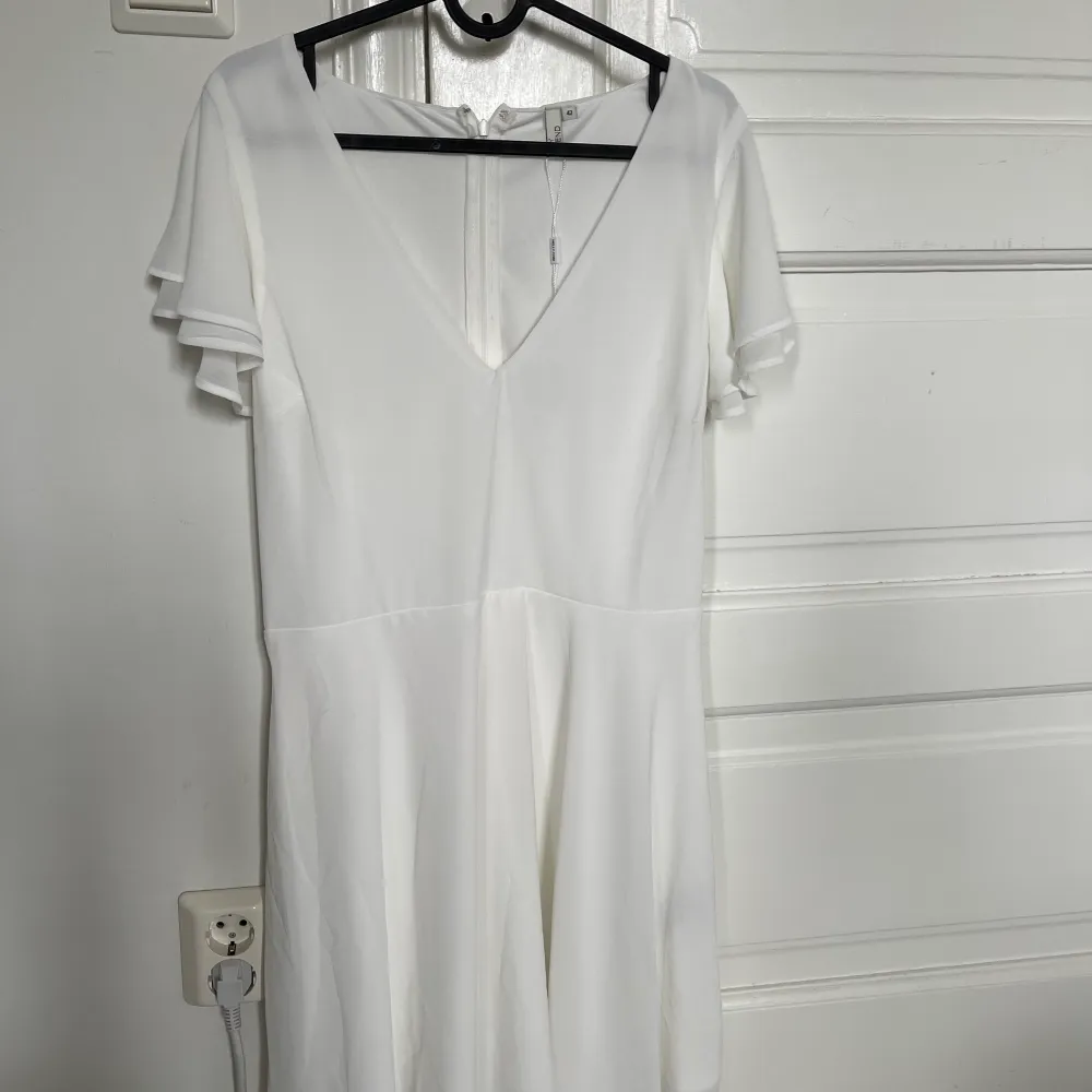 Jag säljer en oanvänd vit klänning med volang ärmar. I midjan har den ett snöre som sedan knyts åt. Prislappen är kvar. Jag säljer denna klänning då jag hittat en annan till min student. . Klänningar.