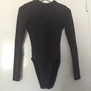 Glittrig Body öppen rygg - Mörkgrå färg med glittrar. Stl S. Stretchigt. H&M. Använd endast 2ggr. Så gott som ny!