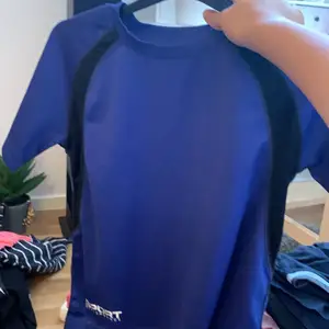 En blå svart tränings tröja i storlek 134/140