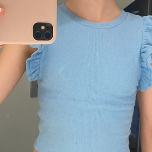 Blå topp me volanger💙 - Blå topp från Zara med volangärmar. I bra skick då en bara använts ett fåtal gånger, på bilen ser den ut att vara lite svart luddig men de är på grund av en sweatshirt som har fått den att bli så. Den tvättas innan köp!!😃 Storlek S men skulle säga att den passar mindre!! Gäller att vara snabb för dessa plagg brukar säljas snabbt!! Kontakta mig privat om du har frågor eller vill ha fler bilder på den!!💗 Köptes för 90kr. 