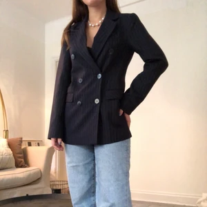 Svart randig kavaj - Svart kavaj som sitter fint på kroppen. Kan användas både med någon fin topp under eller som den är, med inget under. Lent svart material på insidan som ökar bekvämlighet. Har användts endast enstaka gånger men har tyvärr inte plats i min garderob längre. Pris kan diskuteras. Skriv om ni har frågor:)