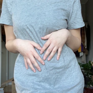 GRÅ T-SHIRTKLÄNNING - Grå och skön tshirtklänning i använt men gott skick! Säljes pga att den inte längre används och är aningen för liten för mig. 