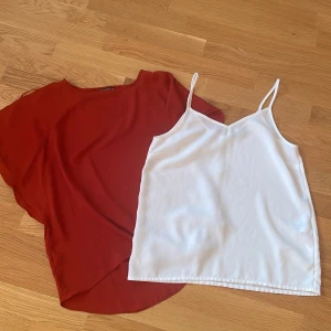 Toppar olika  - Röd topp från Terranova (finns ej i Sverige). Den vita toppen kommer ifrån Vero Moda. 40 kr per topp. 