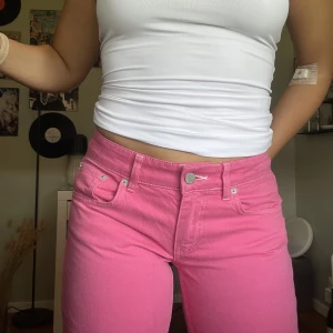 Rosa jeans - As coola rosa lågmidjade jeans från Nelly med vita sömmar!! Passar någon runt 160-170,  Frakt tilkommer 