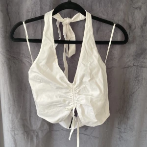 Topp H&M - Vit topp från h&m i storlek S med knytning i nacken. Aldrig använd! 