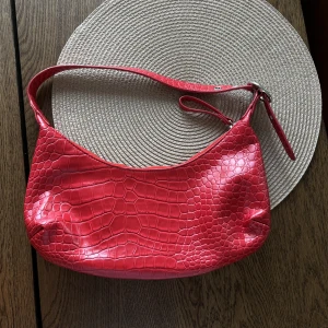 Väska - Snygg röd väska från NAKD. Använd fåtal gånger, den är rymlig inuti. 