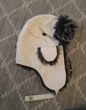 Ushanka - Säljer vibter mössa köpt för länge sen men fortfarande i bra skick. Skriv om ni har fler frågor. 
