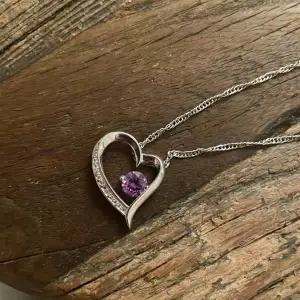 Så fint halsband med ett hjärta med en lila diamant samt småstenar på!💜 alla stenar sitter kvar!