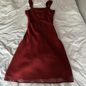 Röd långklänning - Hur fin som helt men passade inte mig. Köpte den secondhand och den är  insydd. Lite glansigt material❤️(små ojämnheter i tyget som inte syns när den är på, bild 3)
