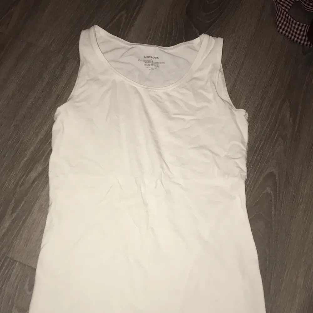 Cotton tank top in good condition save for a removable stain. . T-shirts.
