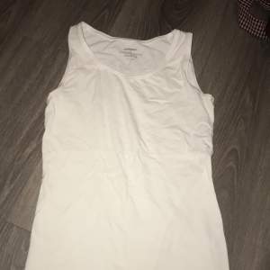 Cotton tank top in good condition save for a removable stain. 