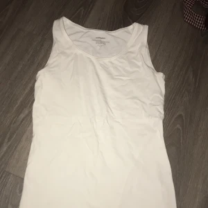 NewBody tank top  - Cotton tank top in good condition save for a removable stain. 