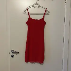 Figursydd röd klänning, kort modell. Oanvänd! 